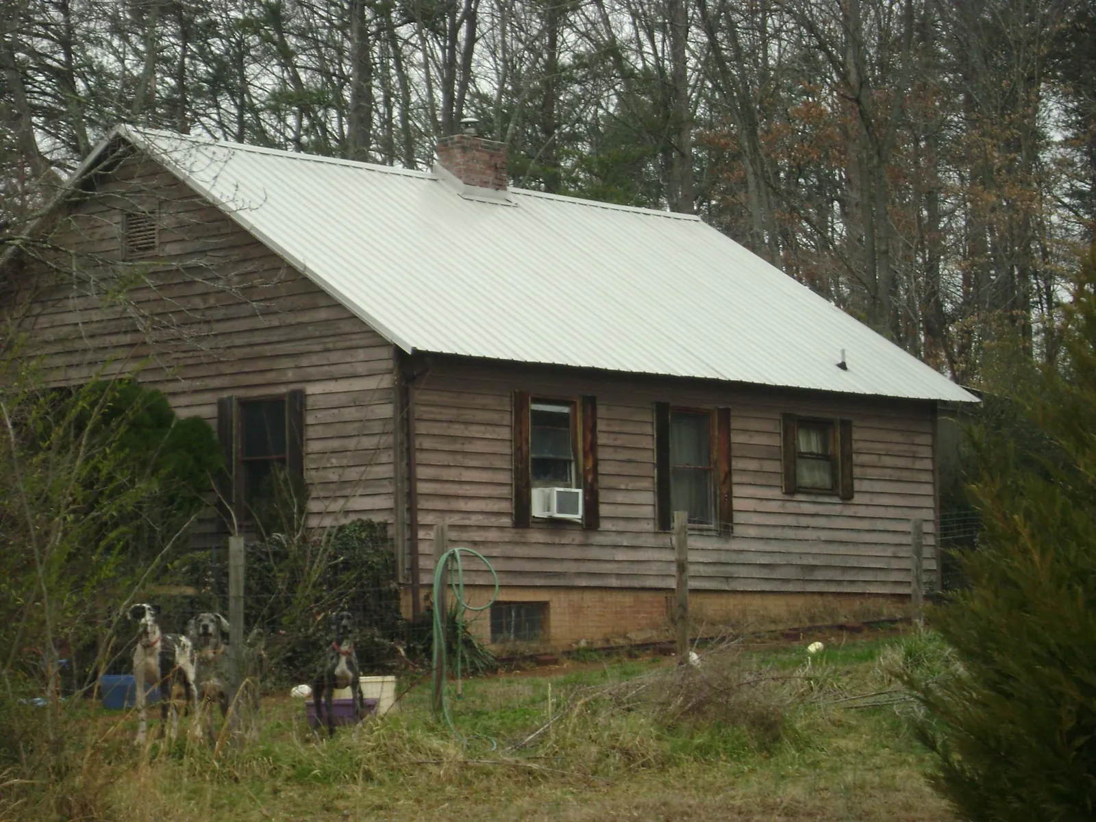 White metal roof on an old wood sided farmhouse, from a Asphalt Shingle Roof Repair job in West Warren